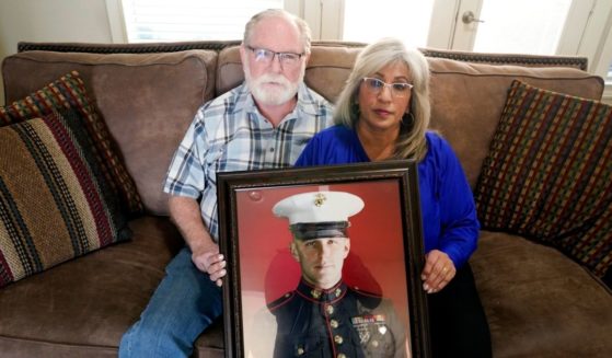 Joey and Paula Reed hold a portrait of their son, Marine Corps veteran and Russian prisoner Trevor Reed, at their home in Fort Worth, Texas, on Feb. 15.