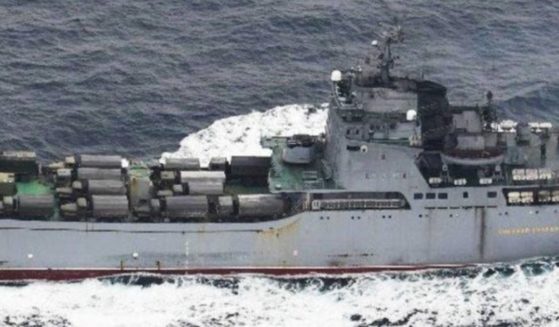 A photo taken by the Japanese Defense Ministry shows a Russian tank landing ship with vehicles on its deck.