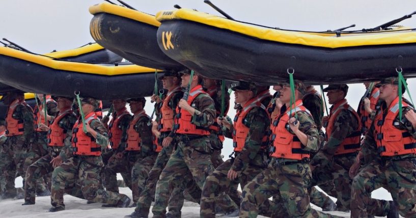 Navy SEAL trainees participate in training exercises, carrying inflatable boats at Naval Amphibious Base Coronado in Coronado, California, on May 14, 2009.