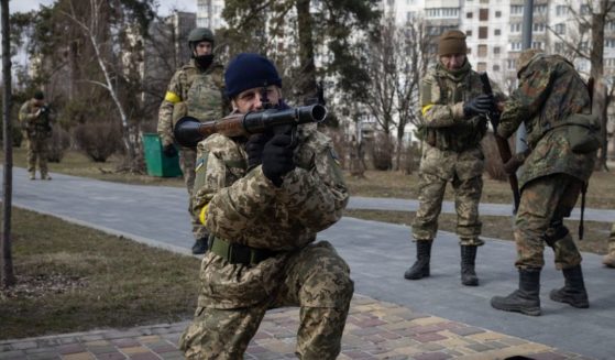 Members of the Ukrainian military reserves, known as the Territorial Defence Forces, learn how to use weapons during a training session Wednesday in Kyiv, Ukraine.