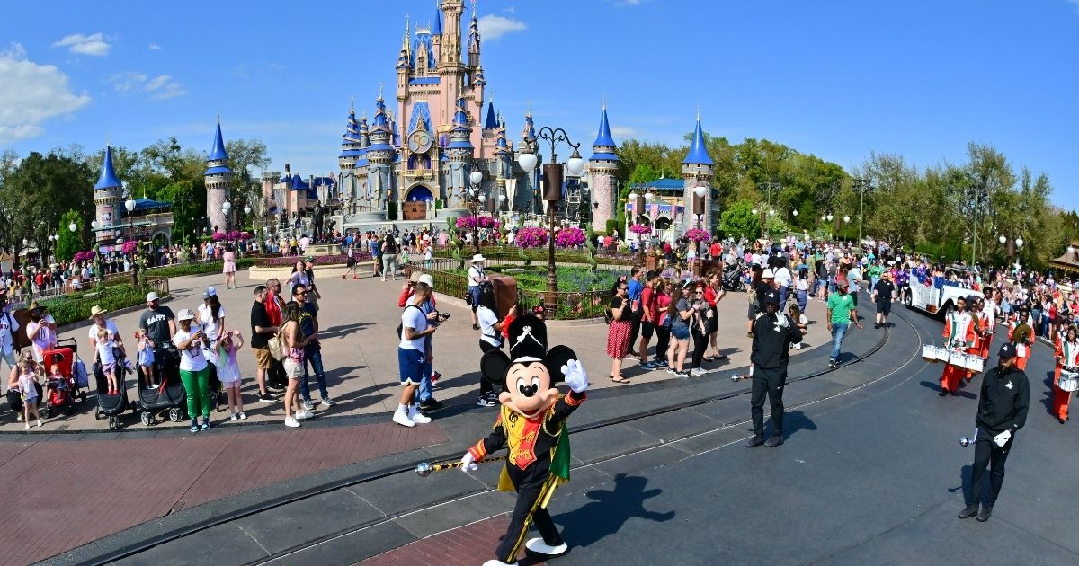 Mickey Mouse waves during a parade at Walt Disney World Resort on March 3, 2022, in Lake Buena Vista, Florida. Four Disney employees have been arrested in an undercover operation by the Polk County Sheriff’s Office in the state.