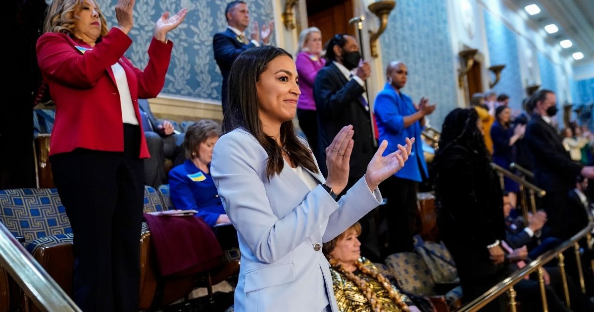 U.S. Rep. Alexandria Ocasio-Cortez, a Democrat from New York, claps as President Joe Biden delivers the State of the Union address on March 1, 2022, at the U.S. Capitol in Washington, D.C.
