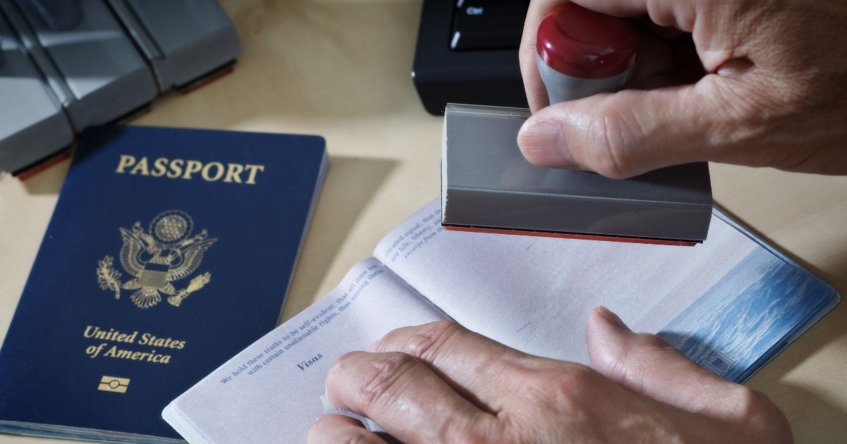 A U.S. border agent inspects a passport.
