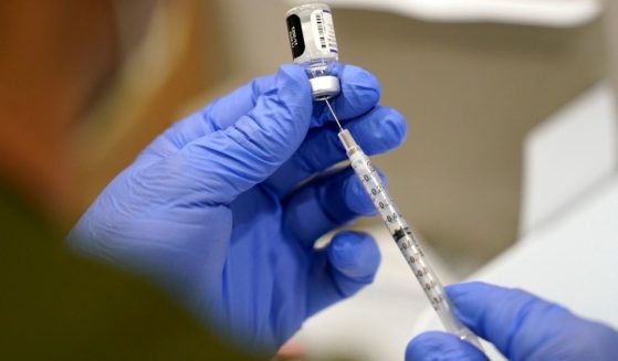 A medical professional prepares a syringe with the Pfizer COVID-19 vaccine in Jackson Memorial Hospital in Miami, Florida, on Oct. 5, 2021.
