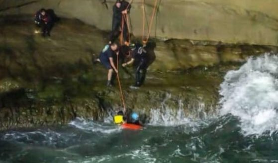 San Diego firefighters and lifeguards rescue two people from the waters off Sunset Cliffs.