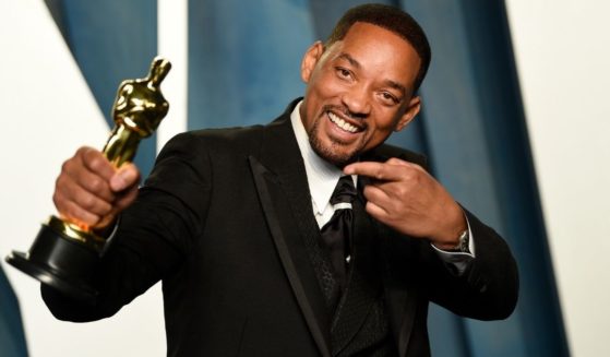 Will Smith poses with his Oscar, all smiles, at the Vanity Fair Oscar Party mere hours after hitting Chris Rock on the stage.