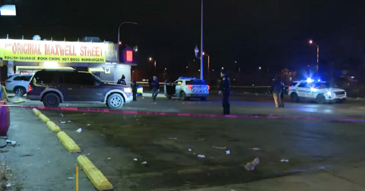 Police officers on the scene Friday morning of a shooting at a Chicago hot dog stand that left two officers wounded.