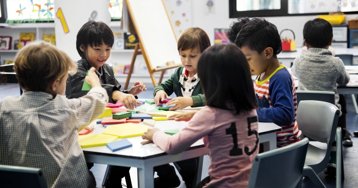 Children sit in a classroom in this stock image.