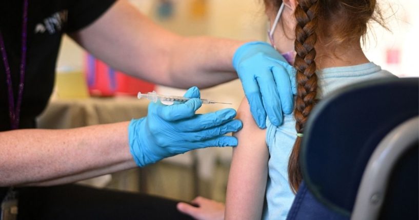 A nurse administers a dose of the COVID-19 vaccine to a girl at a vaccination clinic at Los Angeles Mission College in Los Angeles on Jan. 19.
