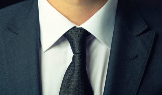 A man wearing a suit is seen in this stock image.
