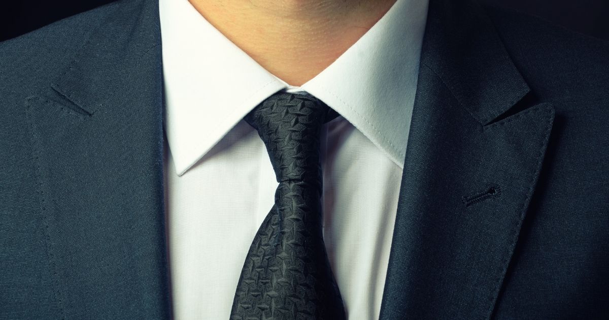 A man wearing a suit is seen in this stock image.