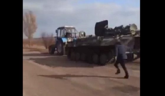 A still shot from a video posted by British Member of Parliament Johnny Mercer that purportedly shows a Russian military armored vehicle being towed by a Ukrainian tractor.