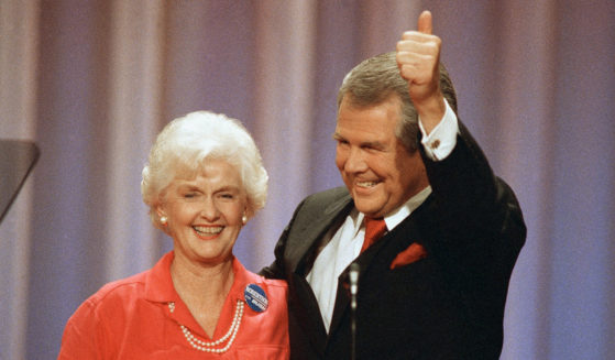 Former presidential hopeful Pat Robertson gives a thumbs-up as he and his wife, Dede, acknowledge applause at the Republican National Convention in New Orleans on Aug. 17, 1988.