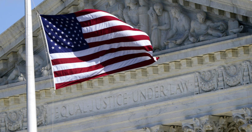 a U.S. flag flying outside the Supreme Court building