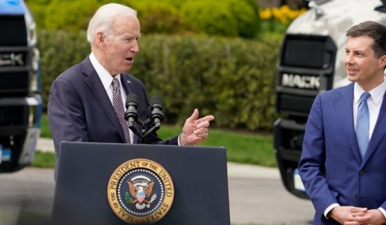 Transportation Secretary Pete Buttigieg listens as President Joe Biden speaks about the trucking industry on the South Lawn of the White House in Washington on Monday.