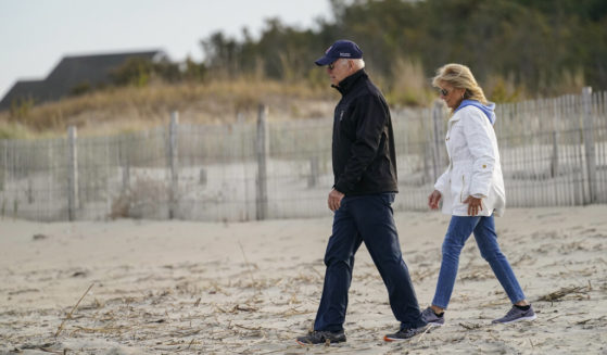President Joe Biden and first lady Jill Biden walk along the beach in Rehoboth Beach, Del., in a file photo from November 2021. Biden spent close to 30 percent of his time in Delaware during the first year of his presidency, yet the Secret Service has said there are no visitor logs for either of Biden's homes in the state.
