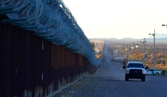 A Border Patrol vehicle drives along the U.S.-Mexico border in Douglas, Arizona, on Dec. 15, 2020.