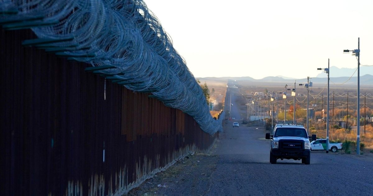A Border Patrol vehicle drives along the U.S.-Mexico border in Douglas, Arizona, on Dec. 15, 2020.