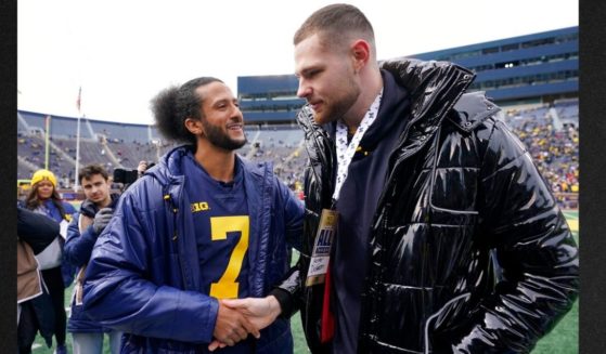 Michigan honorary football captain Colin Kaepernick meets with Hunter Dickinson before an NCAA college football intra-squad spring game April 2 in Ann Arbor, Mich. Kapernick has put out multiple pleas to the NFL to bring him on, even as a backup quarterback.
