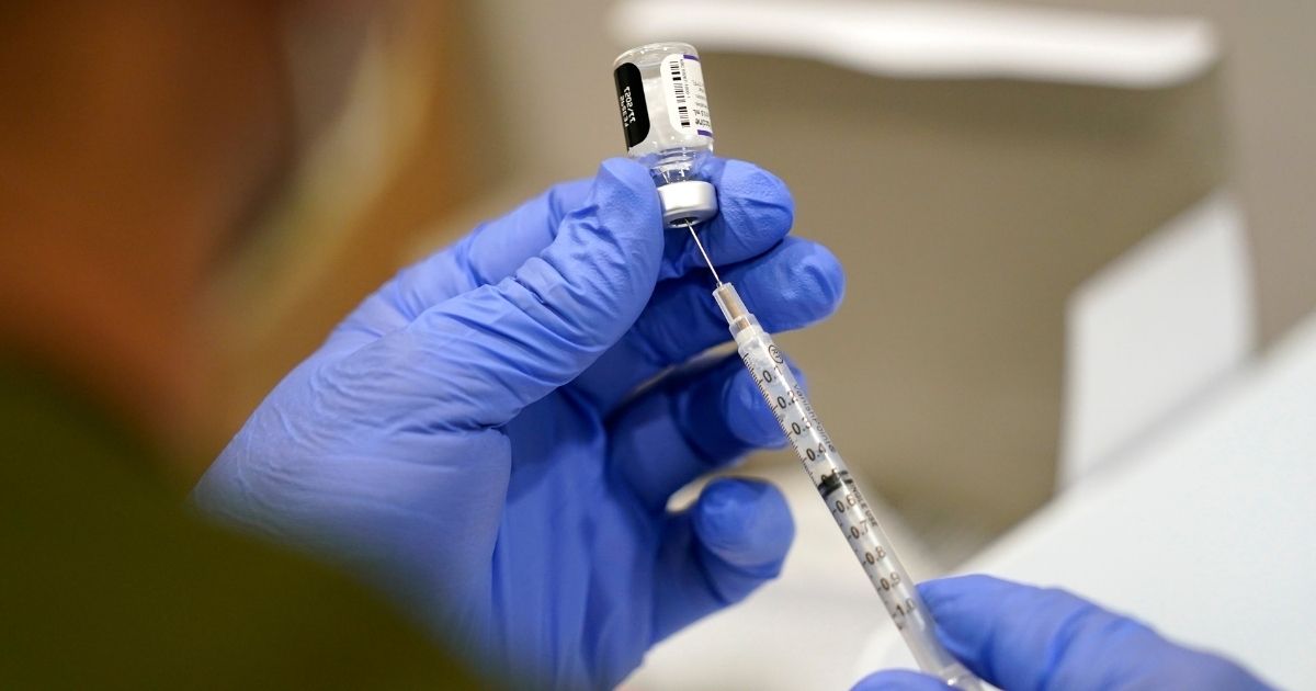 A healthcare worker prepares a COVID-19 vaccine at Jackson Memorial Hospital in Miami, Florida, on Oct. 5, 2021.
