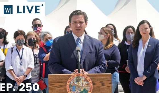 Florida Gov. Ron DeSantis speaks during a news conference surrounded by officials and cruise workers on April 8, 2021, at PortMiami in Miami.