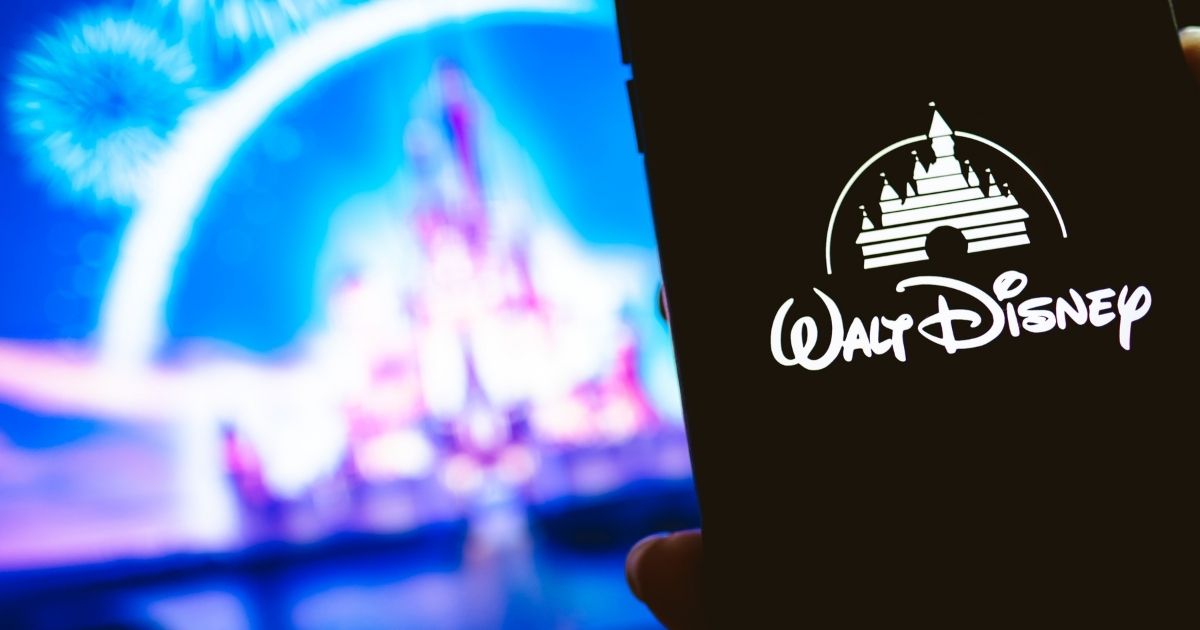 The Disney logo is displayed on a cellphone in this stock image.