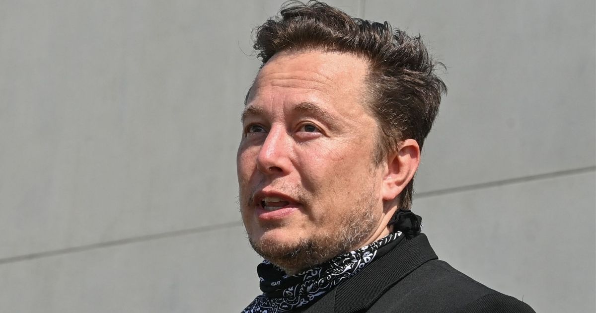 Elon Musk talks to reporters as he visits the Tesla Gigafactory plant under construction in Gruenheide, Germany, near Berlin, on Aug. 13.
