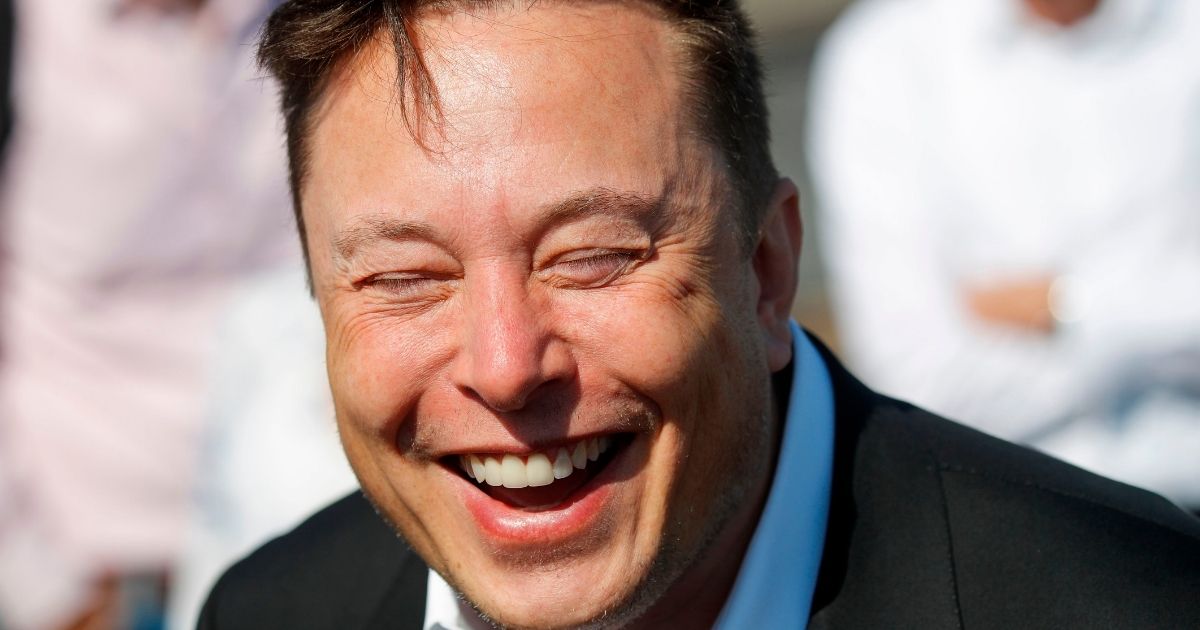 Elon Musk, self-made billionaire and Tesla CEO, laughs while talking to the media at the construction site of the Tesla "Gigafactory" in Gruenheide, Germany, on Sept, 3, 2020.