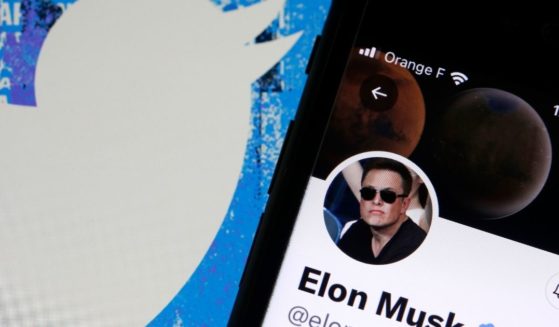 Elon Musk’s Twitter account is displayed on the screen of an iPhone in front of the homepage of the Twitter website on Tuesday in Paris.