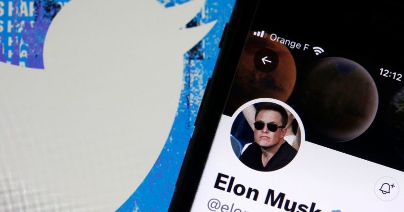 Elon Musk’s Twitter account is displayed on the screen of an iPhone in front of the homepage of the Twitter website on Tuesday in Paris.