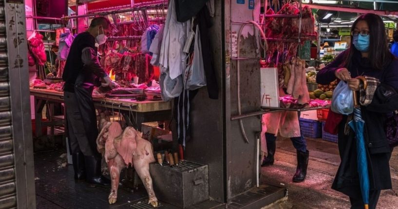 A butcher prepares meat at a fresh food market in Hong Kong on March 24.