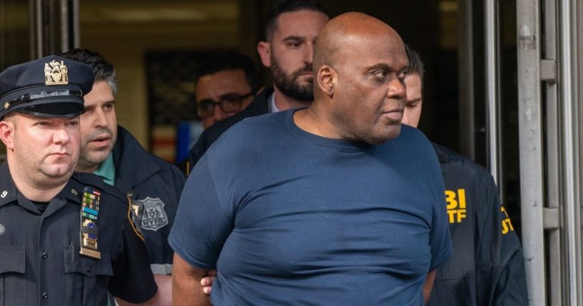 Frank James is escorted by police after being arrested in connection to a mass shooting on Wednesday in New York City.