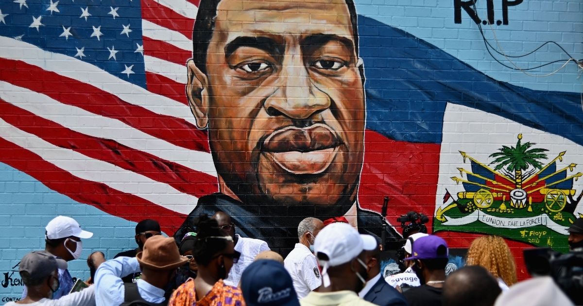 People gather at the unveiling of a memorial portrait of George Floyd on July 13, 2020, in Brooklyn, New York.