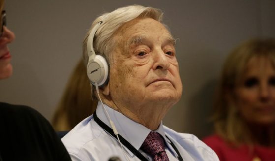 George Soros wears headphones at a U.N. summit on refugees