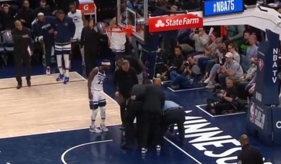 A woman glued herself to the court at Target Centre in Minneapolis during an NBA playoff game.