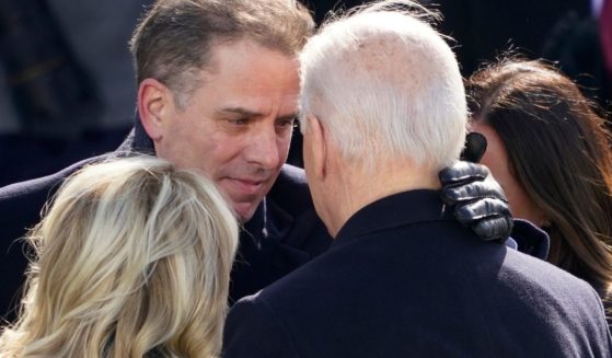 Jill Biden, left, Hunter Biden, center, and Joe Biden, right, embrace after Joe Biden is sworn in as president on Jan. 20, 2021.
