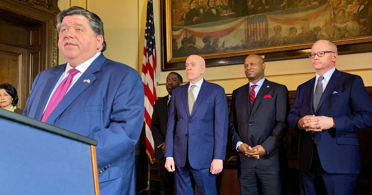Democratic Gov. J.B. Pritzker, left, speaks in Springfield, Illinois, on March 24.