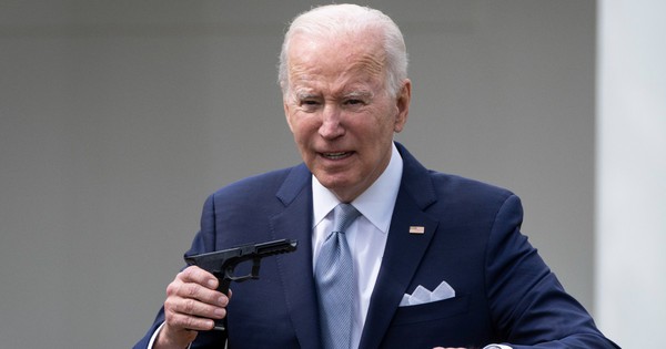 President Joe Biden holds up a ghost gun kit