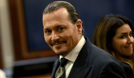 Johnny Depp smirks in the courtroom at the Fairfax County Circuit Courthouse in Fairfax, Virginia, on Tuesday.