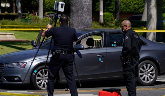 Los Angeles police investigators work at a robbery crime scene in Beverly Hills, California, on June 25, 2021.