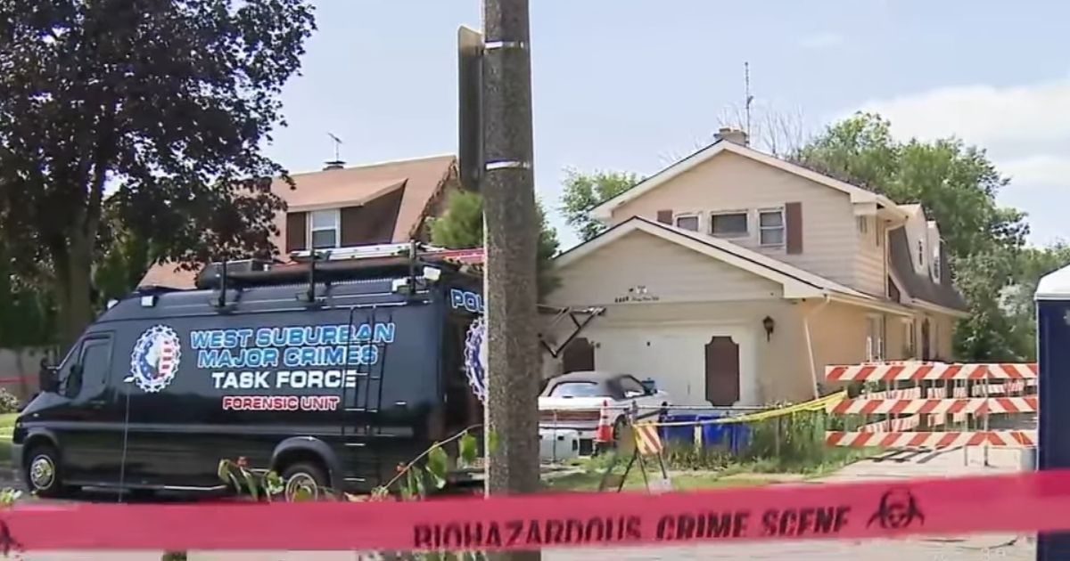 Crime scene tape is posted at the home where two brothers buried their deceased mother and sister in the yard in Lyons, Illinois.