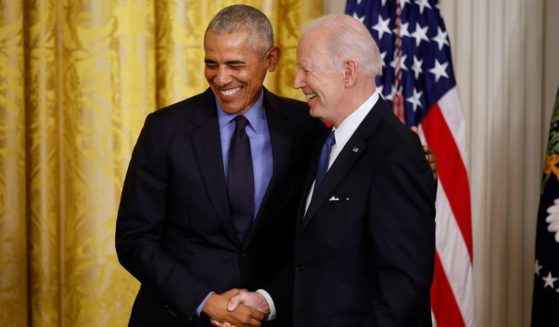 Former President Barack Obama, left, and President Joe Biden shake hands during an April 5 event at the White House. Biden has reportedly told Obama he intends to run again in 2024.