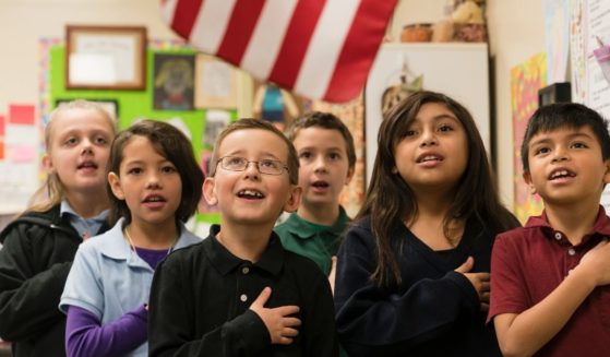 Schoolchildren recite the Pledge of Allegiance.