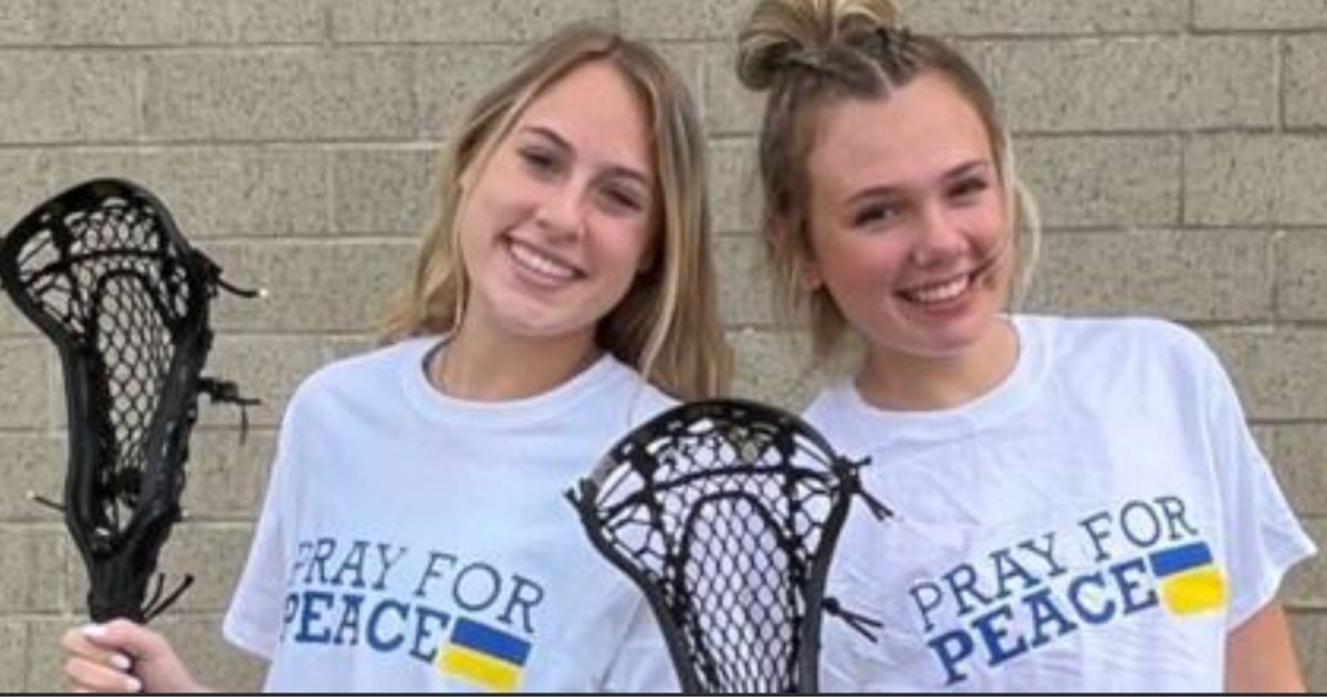 Two members of the Blacksburg High School girls lacrosse team show the "Pray for Peace" t-shirts, which the school board has banned the team from wearing because they are both too political and religious.