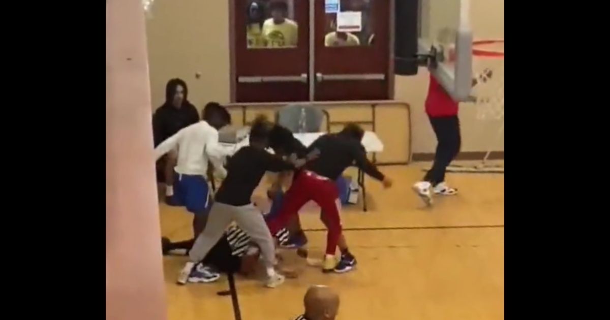 Players and fans gang up on a referee during a youth basketball game that was played at Stronghold Christian Church in Lithonia, Georgia.