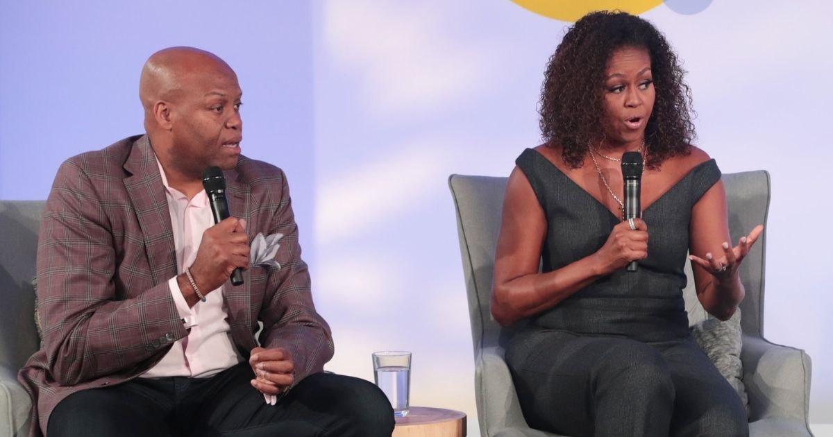 Former first lady Michelle Obama and her brother, Craig Robinson, speak at the Obama Foundation Summit at the Illinois Institute of Technology in Chicago on Oct. 29, 2019.
