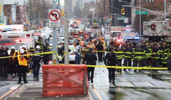 First responders gather near a subway stop entrance in Brooklyn, New York, on Tuesday after multiple people were shot and injured at a subway station.