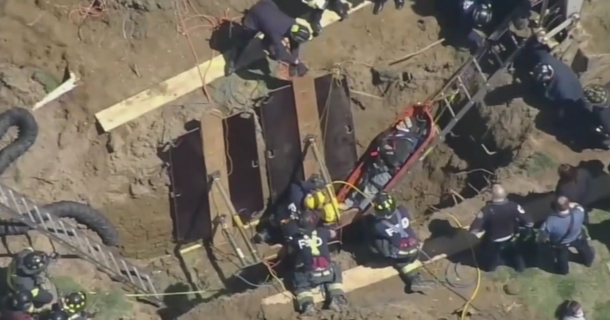 After stabilizing the sides of the trench with large panels, the firefighters were able to load the man onto a stretcher and pull him out.