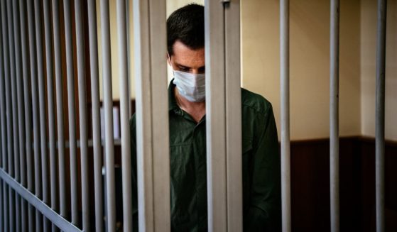 Former U.S. Marine Trevor Reed stands inside a defendant's cage at Moscow's Golovinsky district court in Russia to hear his verdict on July, 30, 2020.