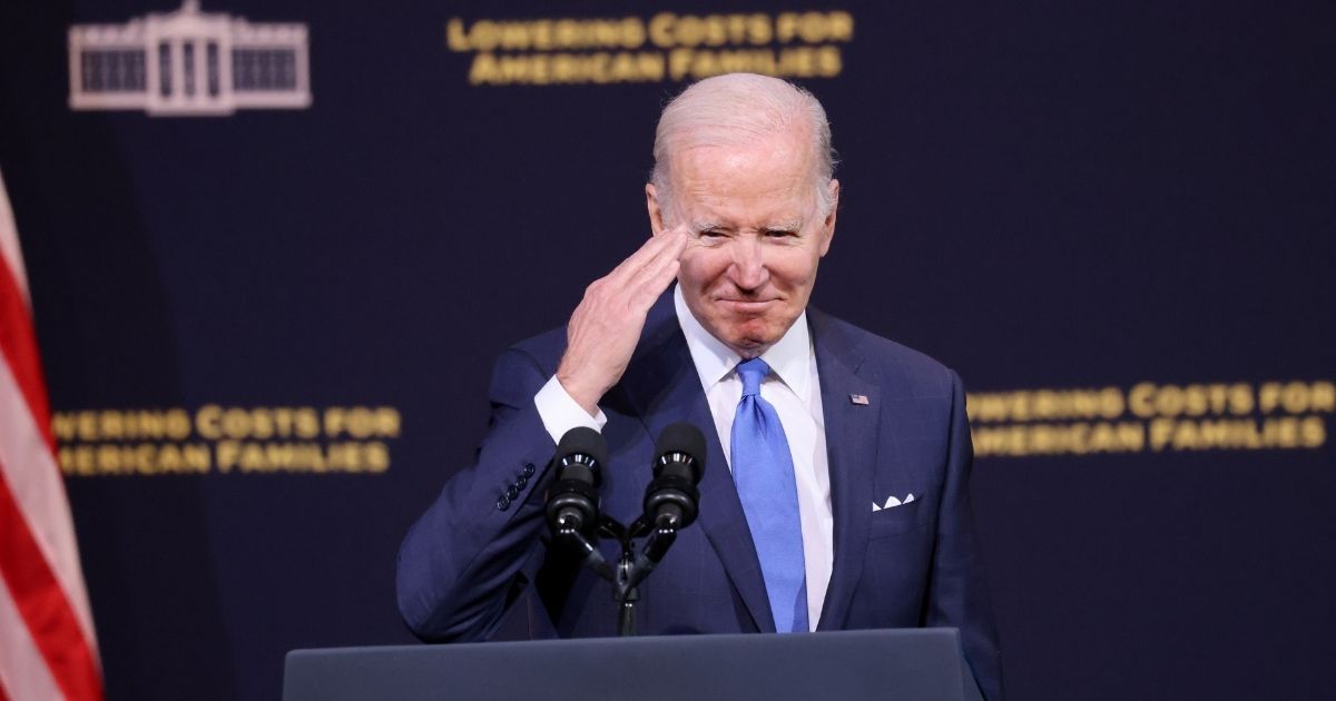 Joe Biden salutes while giving a speech